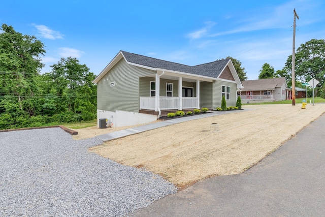312 N Main St, Dickson, TN 37055 - view of front facade featuring covered porch, roof with shingles, and central AC