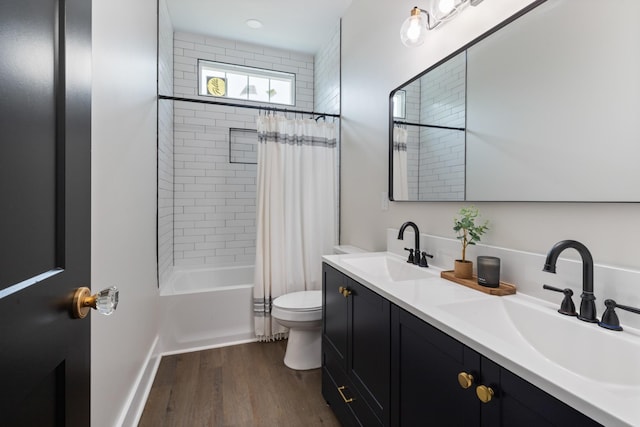 312 N Main St, Dickson, TN 37055 - bathroom with double vanity, toilet, shower / tub combo, and wood finished floors