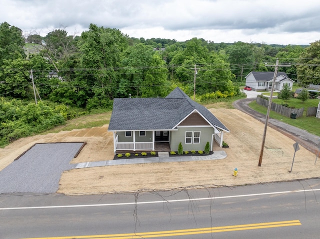 312 N Main St, Dickson, TN 37055 - view of front of property featuring a porch, a view of trees, and a shingled roof