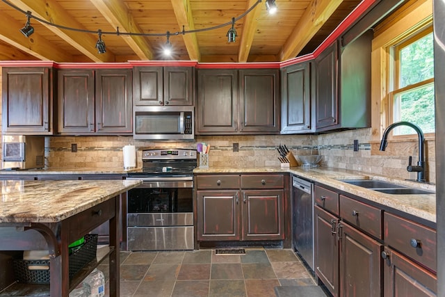 2223 Simmons Ridge Rd, Cornersville, TN 37047 - kitchen with appliances with stainless steel finishes, a sink, rail lighting, wooden ceiling with exposed beams, and tasteful backsplash