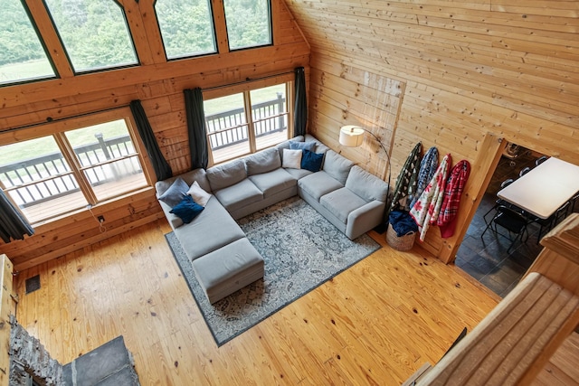 2223 Simmons Ridge Rd, Cornersville, TN 37047 - living room featuring wood walls, wood-type flooring, and a high ceiling