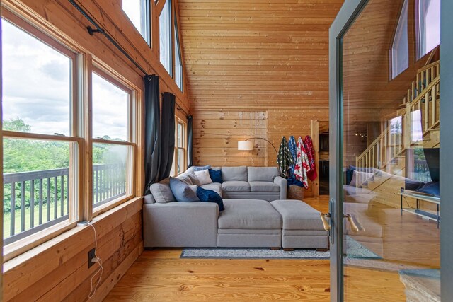 2223 Simmons Ridge Rd, Cornersville, TN 37047 - living area with wooden walls, wood finished floors, stairway, and a towering ceiling