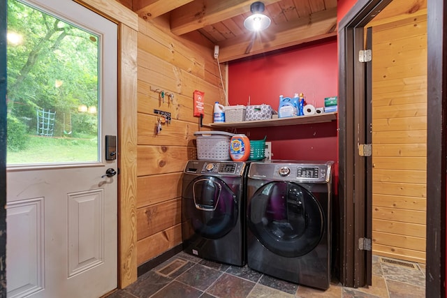 2223 Simmons Ridge Rd, Cornersville, TN 37047 - washroom with dark stone finish floors, washer and clothes dryer, wooden walls, healthy amount of natural light, and wood ceiling