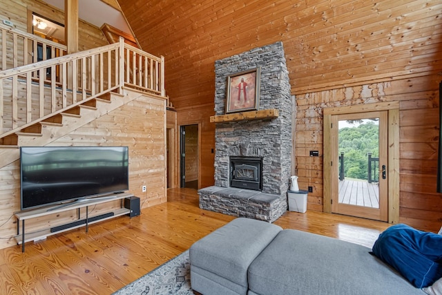 2223 Simmons Ridge Rd, Cornersville, TN 37047 - living room featuring high vaulted ceiling, wood finished floors, a fireplace, wooden walls, and stairway