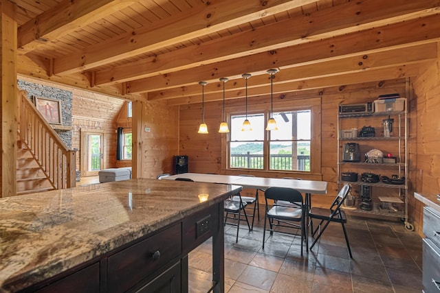 2223 Simmons Ridge Rd, Cornersville, TN 37047 - kitchen with wood walls, light stone counters, wood ceiling with exposed beams, stone tile floors, and pendant lighting