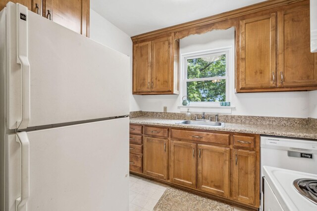 511 Jones St Unit C3, Old Hickory, TN 37138 - kitchen featuring white appliances, a sink, brown cabinetry, and light countertops