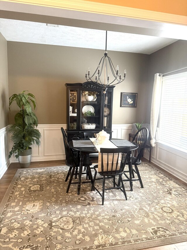 284 Meigs Dr Unit C19, Murfreesboro, TN 37128 - dining area with a chandelier, wood finished floors, a decorative wall, and wainscoting