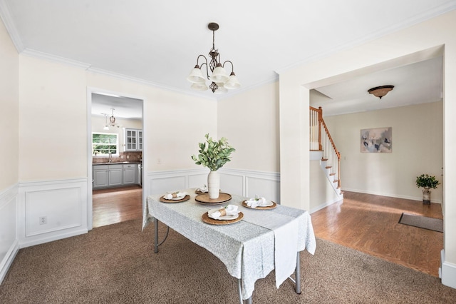 3113 Friars Bridge Pass, Franklin, TN 37064 - dining room featuring carpet, a chandelier, stairway, a wainscoted wall, and ornamental molding