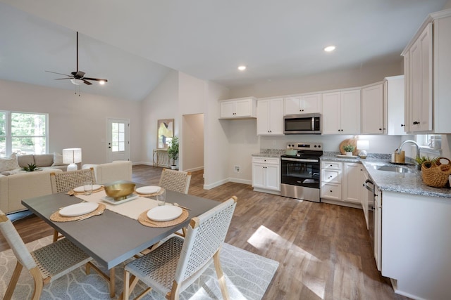 766 Billy Wynn Rd, Dickson, TN 37055 - kitchen featuring stainless steel appliances, a sink, a ceiling fan, white cabinets, and light wood-style floors