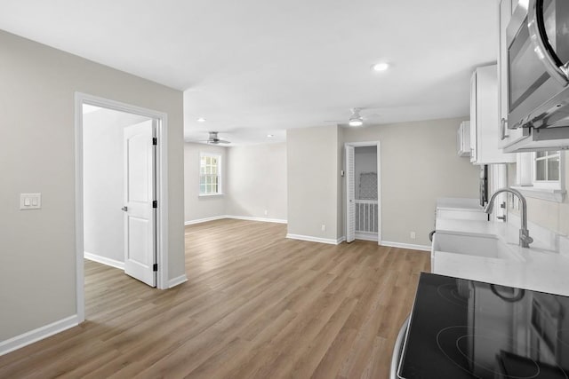 4044 Brick Church Pike, Nashville, TN 37207 - kitchen featuring stainless steel microwave, a ceiling fan, a sink, light countertops, and recessed lighting