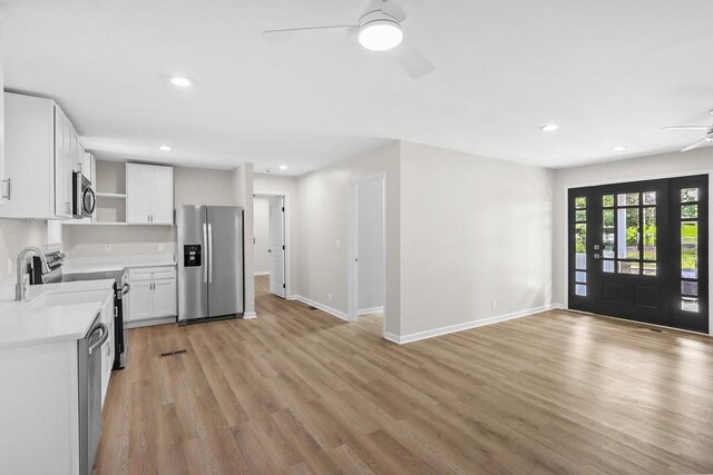 4044 Brick Church Pike, Nashville, TN 37207 - kitchen featuring appliances with stainless steel finishes, ceiling fan, open shelves, light countertops, and light wood-style floors