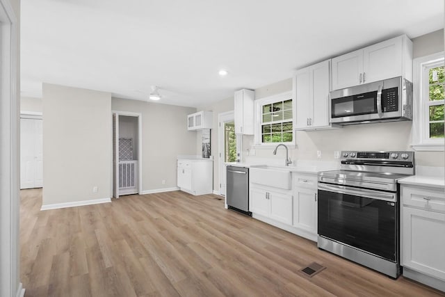 4044 Brick Church Pike, Nashville, TN 37207 - kitchen with stainless steel appliances, a sink, light countertops, white cabinets, and recessed lighting