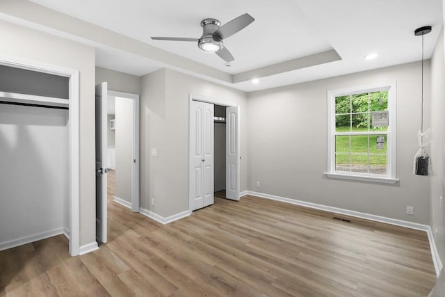 4044 Brick Church Pike, Nashville, TN 37207 - unfurnished bedroom featuring multiple closets, light wood-type flooring, baseboards, recessed lighting, and a ceiling fan