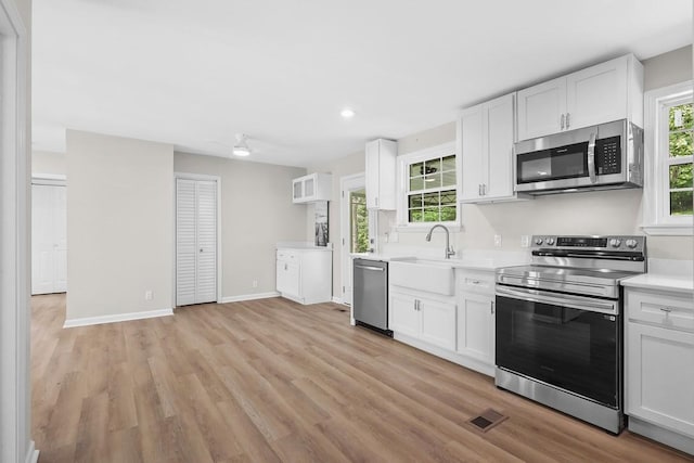 4044 Brick Church Pike, Nashville, TN 37207 - kitchen featuring stainless steel appliances, a sink, light countertops, white cabinets, and recessed lighting