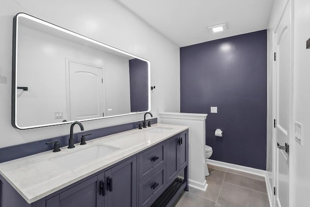 4044 Brick Church Pike, Nashville, TN 37207 - bathroom featuring toilet, double vanity, tile patterned floors, and baseboards
