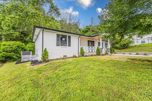 4044 Brick Church Pike, Nashville, TN 37207 - view of front of house with covered porch, a front lawn, and central air condition unit