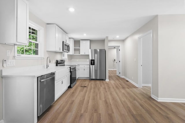 4044 Brick Church Pike, Nashville, TN 37207 - kitchen featuring stainless steel appliances, white cabinetry, light wood-style flooring, open shelves, and recessed lighting