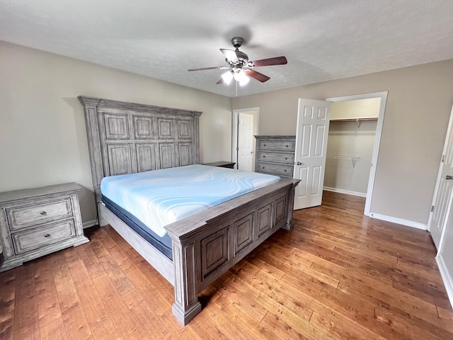 783 Galen Rd, Lafayette, TN 37083 - bedroom featuring light wood-style flooring, baseboards, ceiling fan, a walk in closet, and a closet