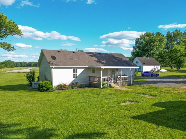 783 Galen Rd, Lafayette, TN 37083 - back of house featuring a lawn, roof with shingles, and central AC