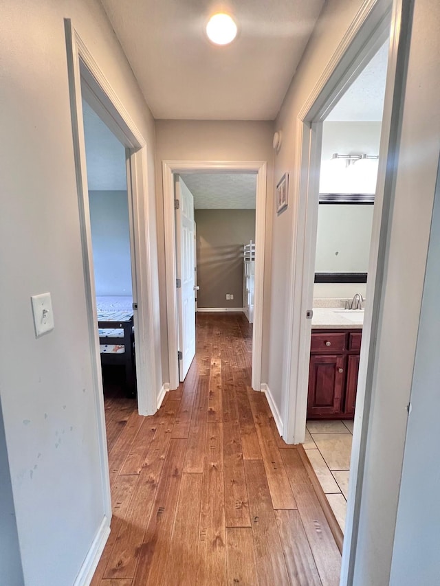 783 Galen Rd, Lafayette, TN 37083 - corridor featuring light wood-type flooring, baseboards, and a sink
