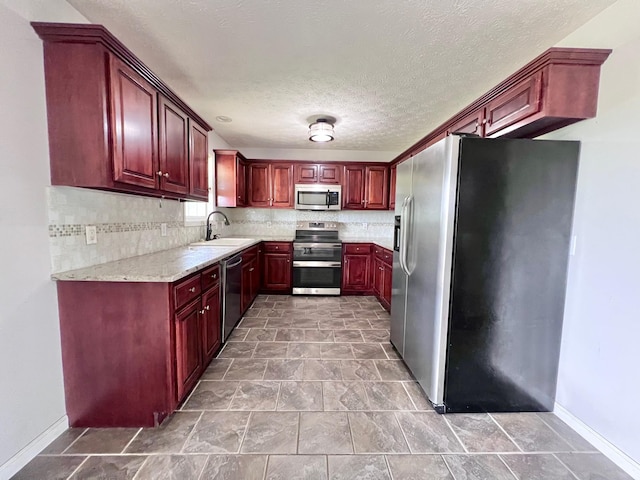 783 Galen Rd, Lafayette, TN 37083 - kitchen with stainless steel appliances, dark brown cabinets, backsplash, a sink, and a textured ceiling