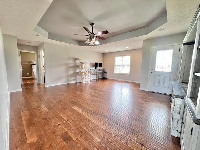 783 Galen Rd, Lafayette, TN 37083 - living area featuring a tray ceiling, baseboards, hardwood / wood-style floors, ceiling fan, and recessed lighting