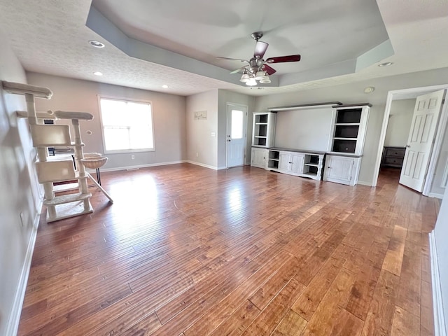 783 Galen Rd, Lafayette, TN 37083 - unfurnished living room featuring baseboards, a ceiling fan, a tray ceiling, wood finished floors, and recessed lighting
