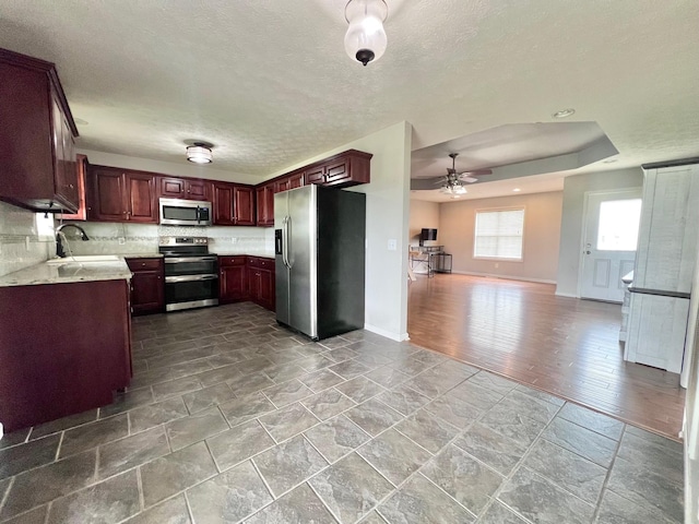 783 Galen Rd, Lafayette, TN 37083 - kitchen featuring appliances with stainless steel finishes, a sink, a ceiling fan, light countertops, and open floor plan