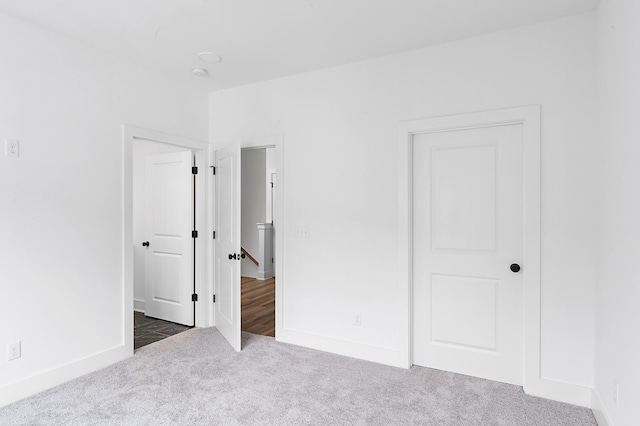 726 N Dupont Ave, Madison, TN 37115 - unfurnished bedroom with dark colored carpet and baseboards