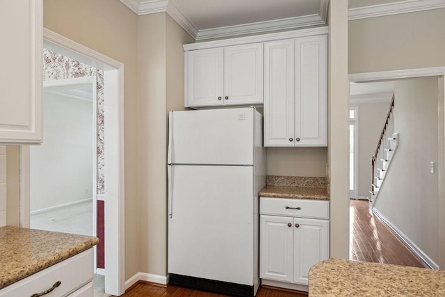 517 Ridgestone Dr, Franklin, TN 37064 - kitchen featuring freestanding refrigerator, ornamental molding, white cabinets, and light countertops