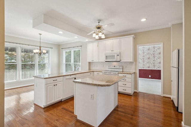 517 Ridgestone Dr, Franklin, TN 37064 - kitchen with white appliances, a sink, a peninsula, dark wood-style floors, and ornamental molding