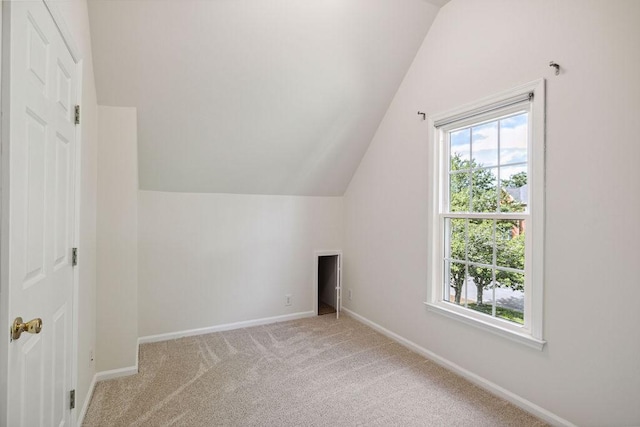 517 Ridgestone Dr, Franklin, TN 37064 - additional living space with vaulted ceiling, baseboards, and light colored carpet