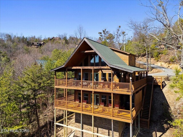 2732 Heather Ln Way, Sevierville, TN 37862 - rear view of house featuring a deck, a shingled roof, and log veneer siding