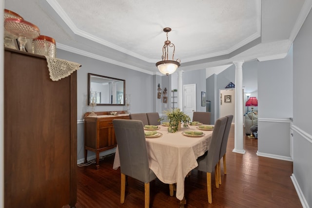 373 Baronswood Dr, Nolensville, TN 37135 - dining space with decorative columns, dark wood finished floors, a tray ceiling, baseboards, and ornamental molding