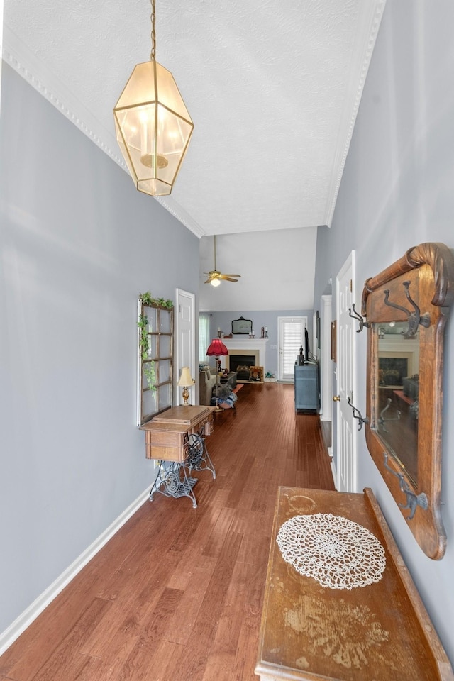 373 Baronswood Dr, Nolensville, TN 37135 - living area featuring a fireplace, wood finished floors, ornamental molding, a textured ceiling, and baseboards