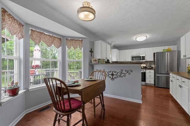 373 Baronswood Dr, Nolensville, TN 37135 - dining area featuring a textured ceiling, dark wood-style flooring, and baseboards