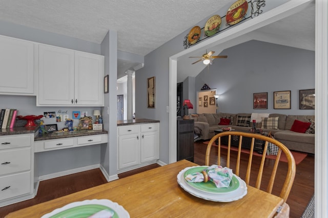 373 Baronswood Dr, Nolensville, TN 37135 - dining area with dark wood-style floors, a ceiling fan, ornate columns, vaulted ceiling, and a textured ceiling