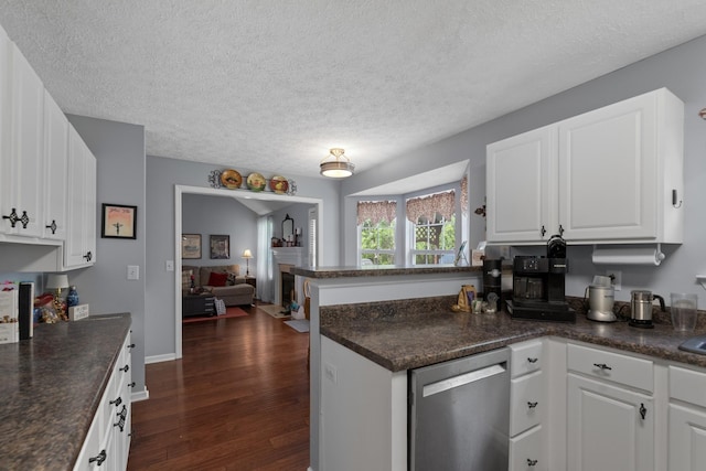 373 Baronswood Dr, Nolensville, TN 37135 - kitchen with dishwasher, a peninsula, dark countertops, dark wood-style flooring, and a textured ceiling