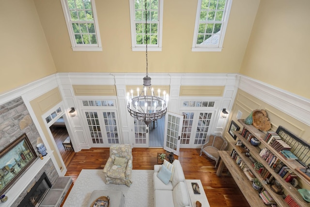 460 Whistler Cv, Franklin, TN 37067 - living room featuring a decorative wall, a wainscoted wall, a chandelier, wood finished floors, and french doors