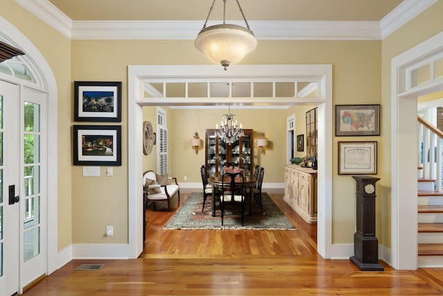 460 Whistler Cv, Franklin, TN 37067 - dining area with crown molding, a chandelier, wood finished floors, stairs, and baseboards