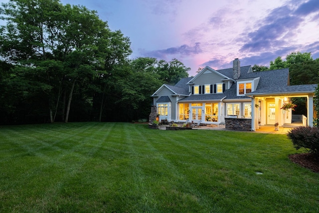 460 Whistler Cv, Franklin, TN 37067 - back of house at dusk featuring a yard, a chimney, french doors, and a shingled roof