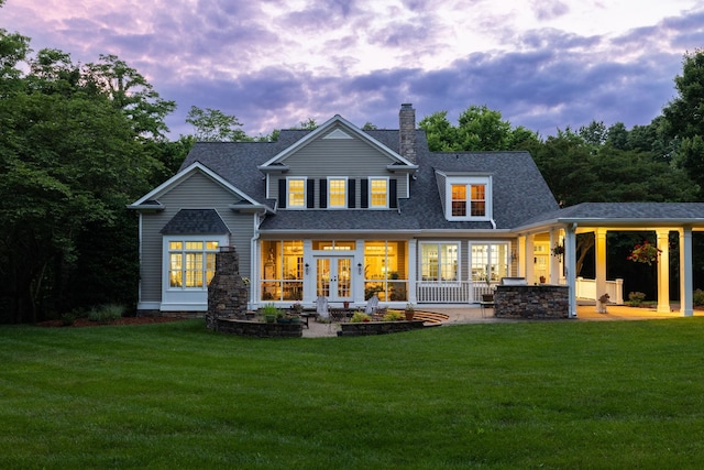 460 Whistler Cv, Franklin, TN 37067 - back of property at dusk with french doors, a lawn, a chimney, and roof with shingles