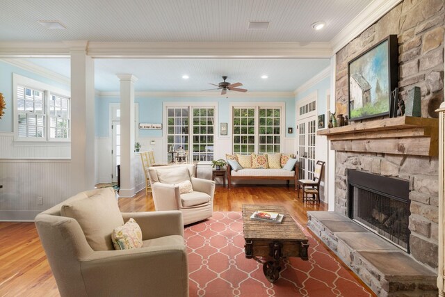 460 Whistler Cv, Franklin, TN 37067 - living room featuring crown molding, a wainscoted wall, a fireplace, a ceiling fan, and wood finished floors