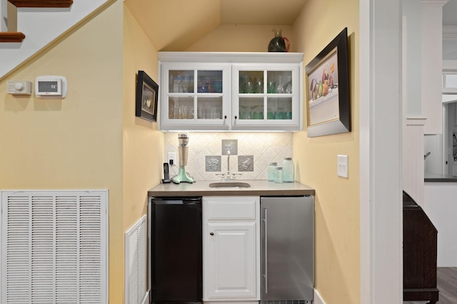 460 Whistler Cv, Franklin, TN 37067 - indoor wet bar with stainless steel fridge, tasteful backsplash, fridge, and lofted ceiling