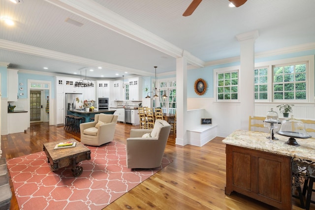 460 Whistler Cv, Franklin, TN 37067 - living room with ornamental molding, wood finished floors, wainscoting, ceiling fan, and decorative columns