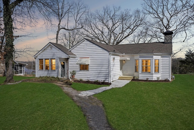 4430 Brush Hill Rd, Nashville, TN 37216 - view of front of house featuring a front yard, a chimney, and roof with shingles
