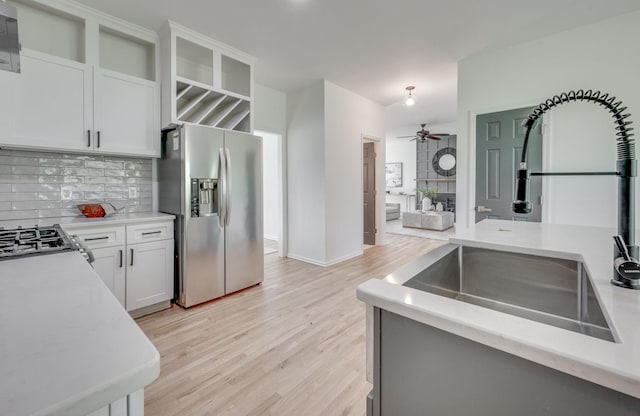608 Claridge Ct, Franklin, TN 37064 - kitchen featuring stainless steel fridge, a ceiling fan, backsplash, a sink, and light wood-style floors