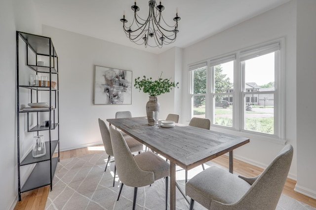 608 Claridge Ct, Franklin, TN 37064 - dining space with a chandelier, light wood-type flooring, and baseboards