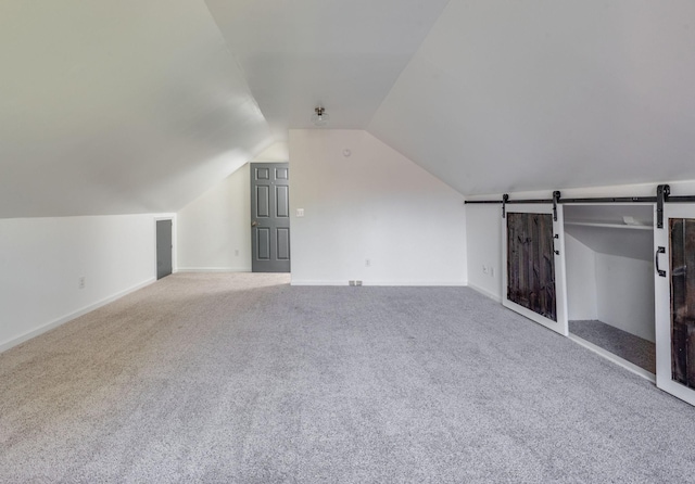 608 Claridge Ct, Franklin, TN 37064 - additional living space with carpet, a barn door, lofted ceiling, and baseboards