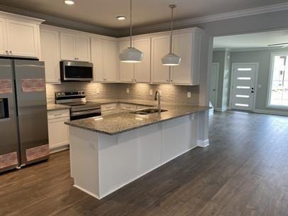 1451 Rebecca Johns Dr, Murfreesboro, TN 37128 - kitchen featuring appliances with stainless steel finishes, crown molding, a sink, white cabinetry, and a peninsula